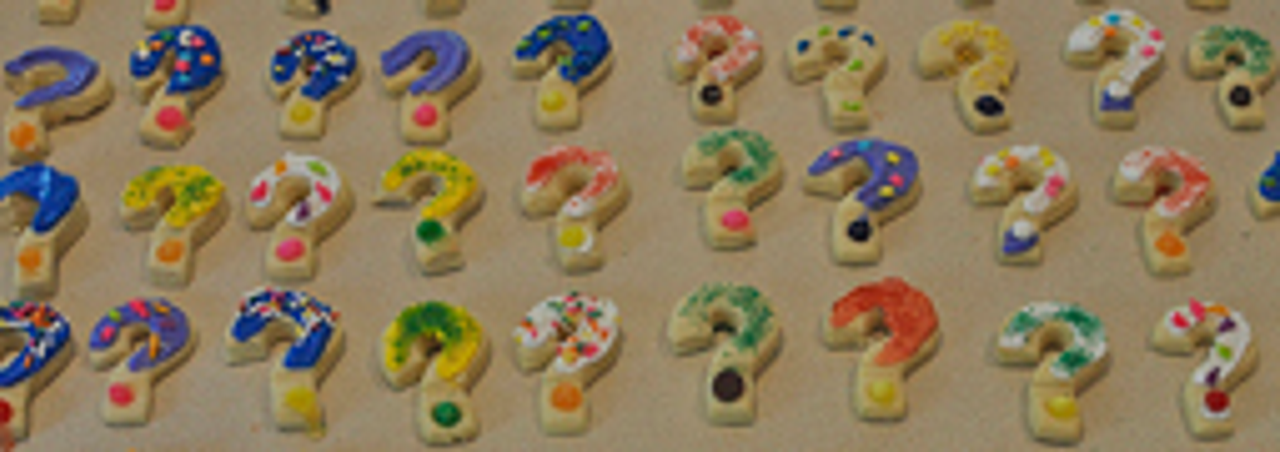 Multi-coloured question mark biscuits