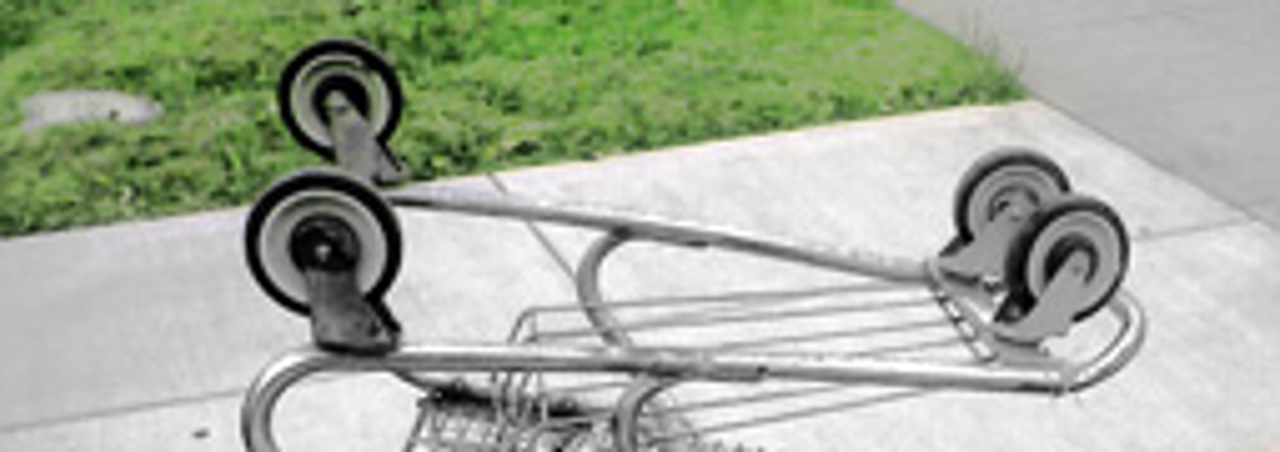 Upside down discarded shopping trolley